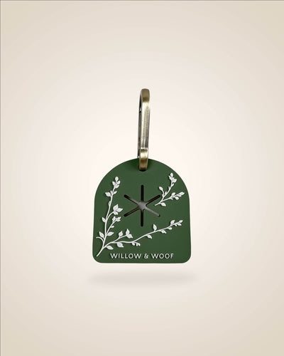 Green dog waste/poop bag carrier, white botanical flowers with bronze tone hardware